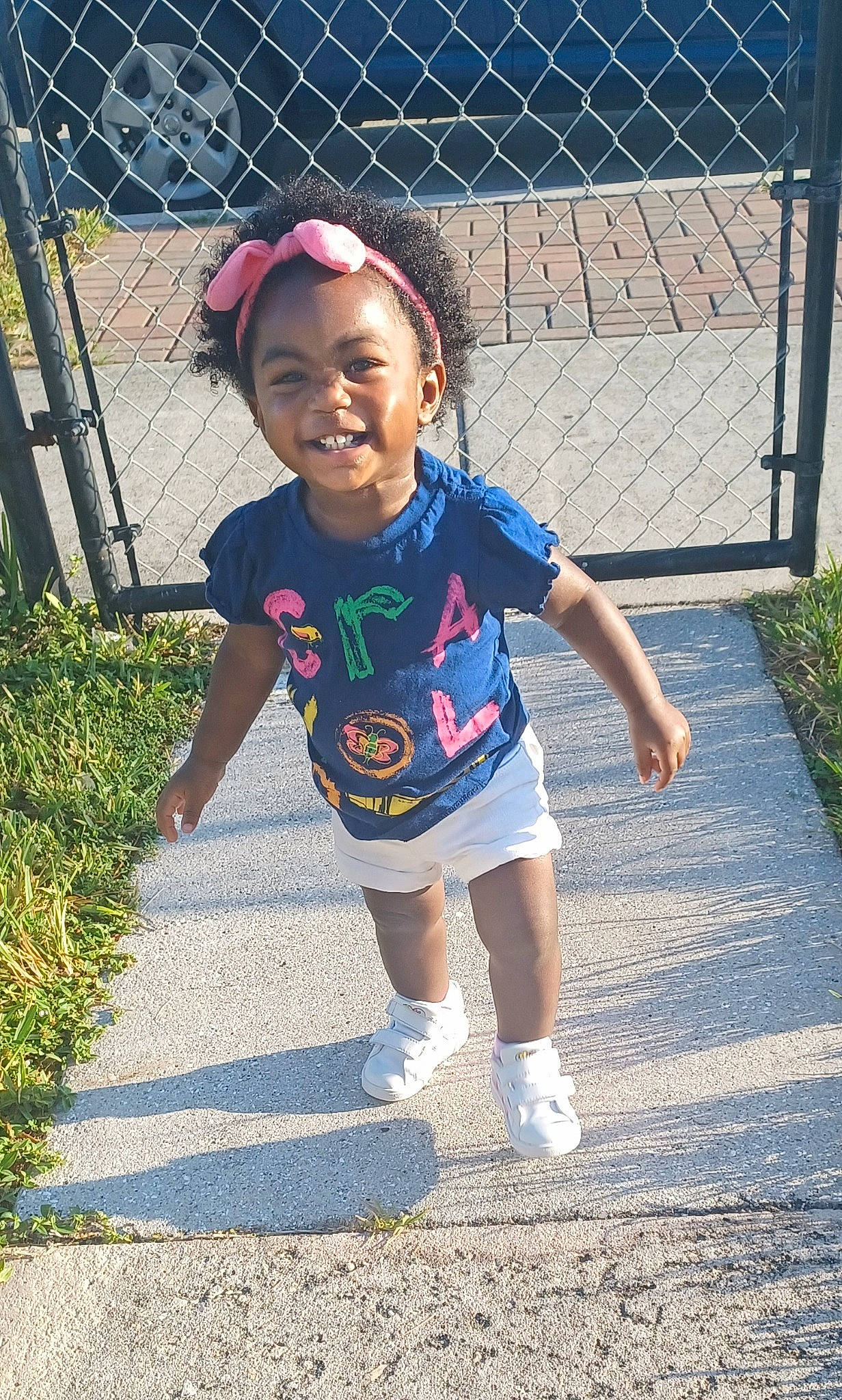 Kenzie joined the competition — help win amazing prizes! asphalt, baby_toddler_clothing, child, electric_blue, eye, fence, grass, happy, hat, joy, leisure, person, recreation, road_surface, shorts, sidewalk, sleeve, smile, t_shirt, toddler