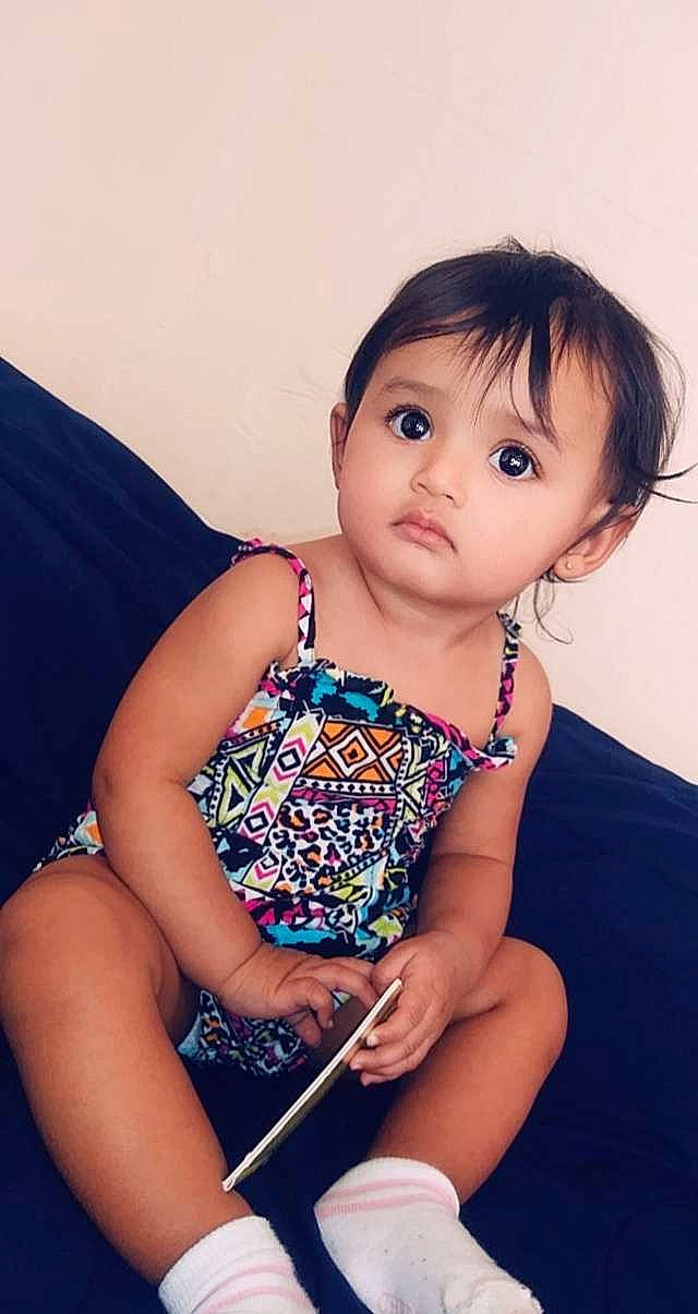 Alessandra is registered to the contest to win money with this photo: black_hair, cheek, child, child_model, leg, neck, person, sitting, skin, smile, thigh, toddler