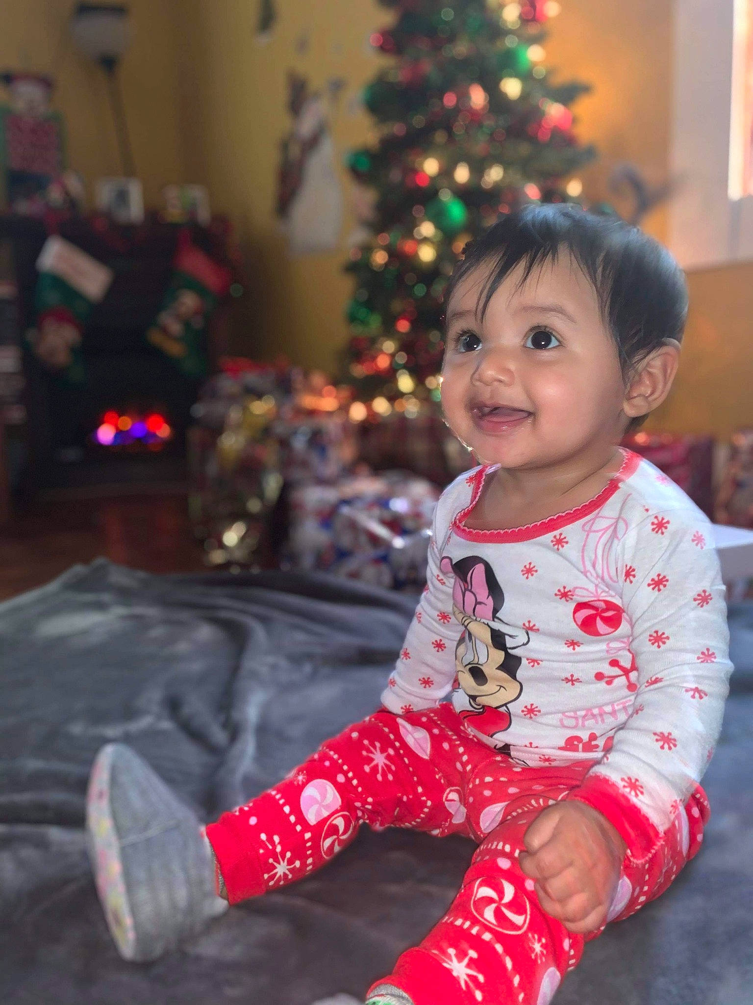 Alessandra joined the competition — help win amazing prizes! baby, child, christmas, christmas_decoration, christmas_eve, christmas_ornament, christmas_tree, event, happy, holiday, pajamas, person, smile, standing, toddler, tree, winter