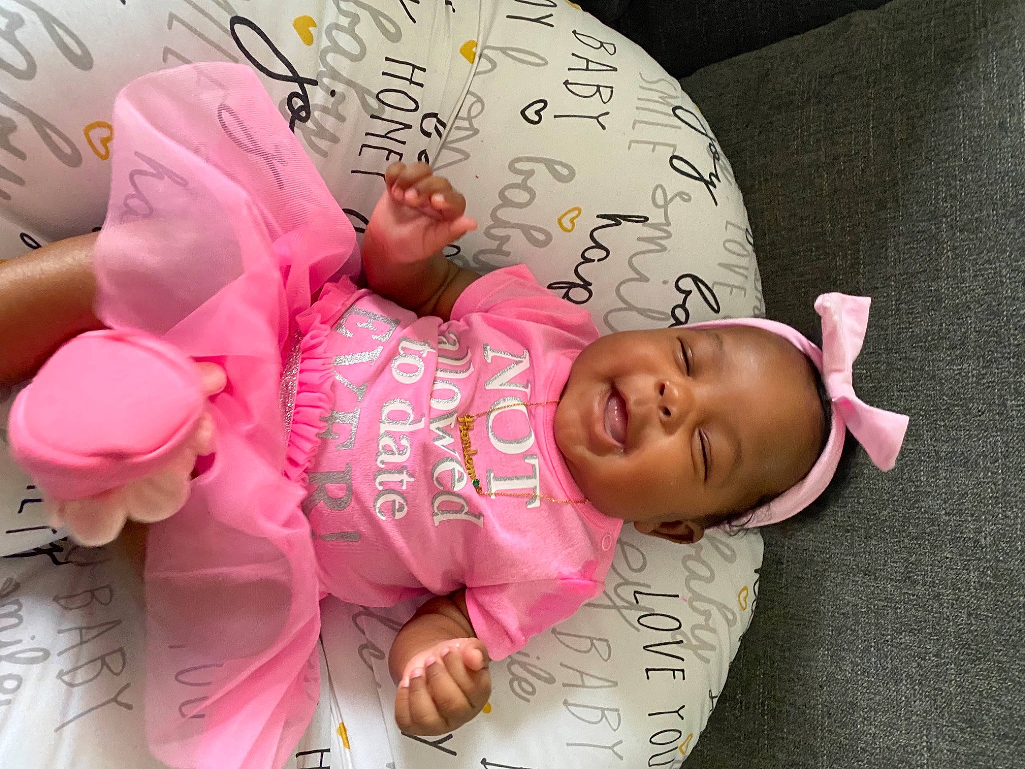 Harlem is registered to the contest to win money with this photo: baby, baby_products, baby_toddler_clothing, beauty, cheek, child, comfort, fashion_accessory, finger, font, happy, headgear, magenta, person, pink, product, room, skin, smile, textile