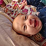 Wyatt joined the competition — help win amazing prizes! baby, smiling, face, blanket, bed, clothing, infant, happy, portrait, cute, child, indoors, head, person, sleepwear, patterned, colorful, closeup, cozy, lying_down
