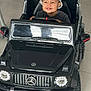 Adnan a rejoint le concours — aidez-le/la à gagner de superbes lots ! toddler, child, toy_car, mercedes, amg, hat, bucket_hat, indoor, floor_tiles, grin, steering_wheel, black_car, playtime, cute, vehicle, smiling, baby, automobile, kid, fun