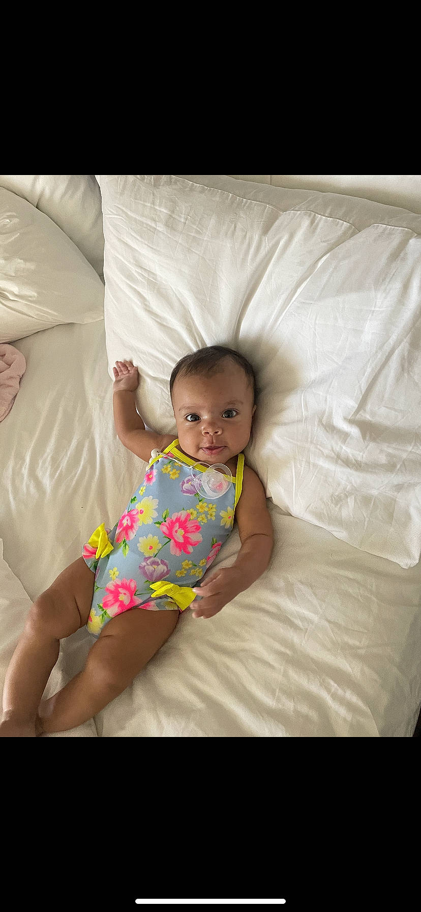 Kamilah is registered to the contest to win money with this photo: baby, baby_toddler_clothing, bedding, child, comfort, fun, happy, human_leg, knee, lap, linens, person, sitting, skin, sleeve, stomach, t_shirt, textile, thigh, throw_pillow