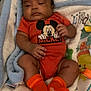 Makaio joined the competition — help win amazing prizes! baby, infant, mickey_mouse, orange_clothing, socks, blanket, soft_toy, sleepy, lying_down, indoors, child, cute, cozy, patterned_blanket, hand, footwear, face, person, toddler, resting