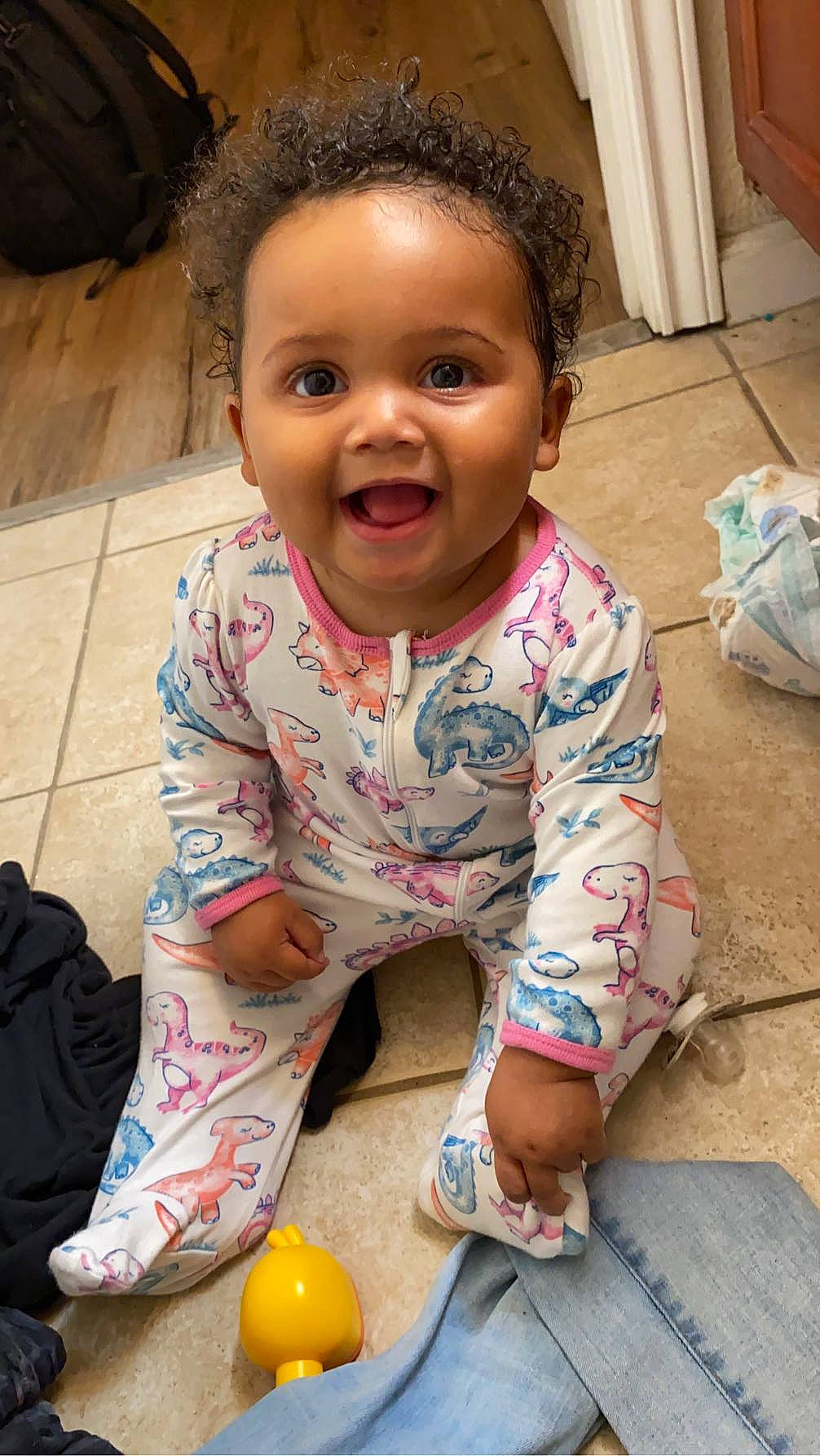 Avelina is registered to the contest to win money with this photo: baby, baby_toddler_clothing, cheek, child, eye, floor, flooring, foot, forehead, fun, happy, human, lip, nose, person, pink, skin, sleeve, smile, thigh