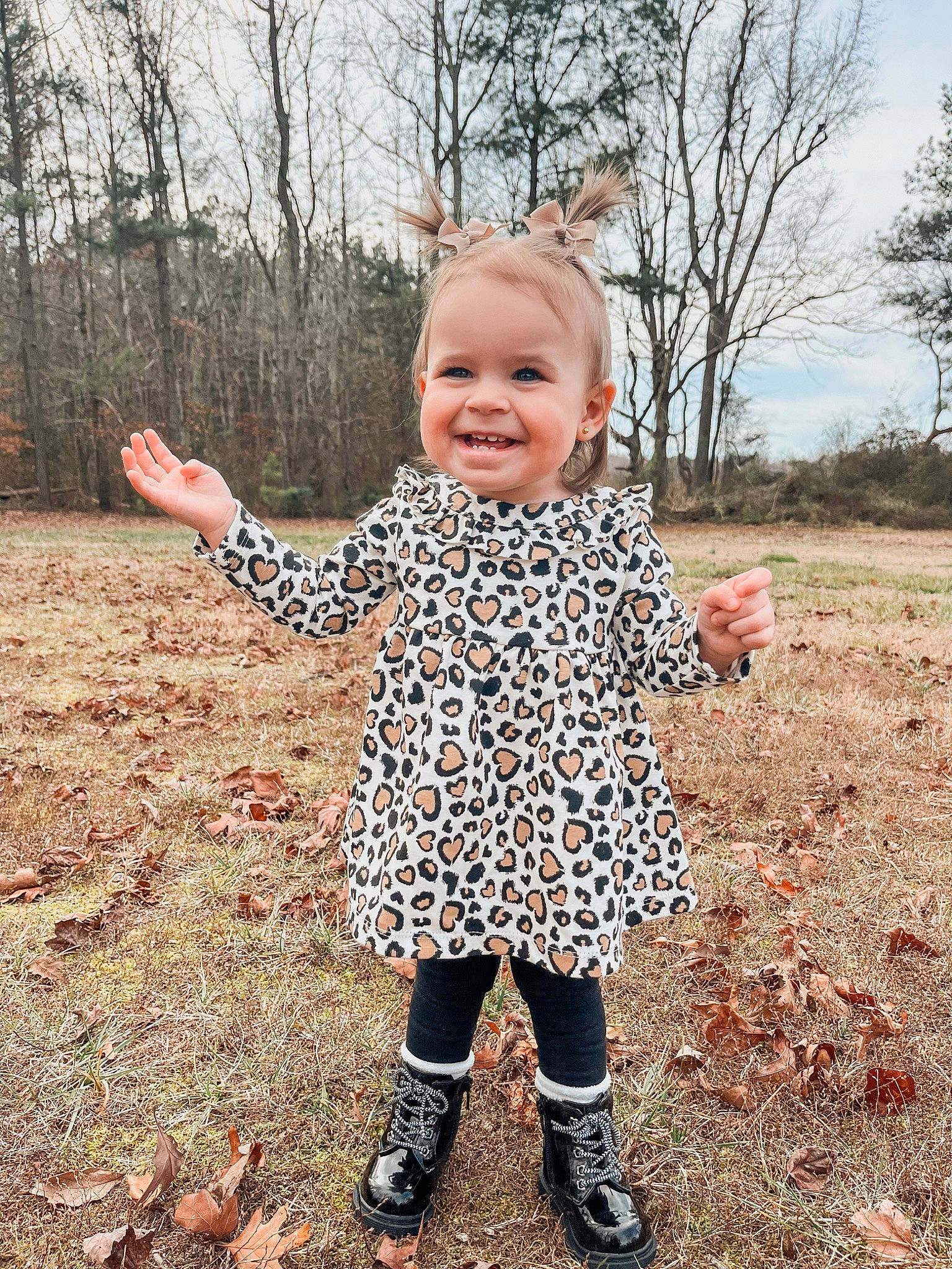 Sutton is registered to the contest to win money with this photo: baby, baby_toddler_clothing, child, eye, finger, gesture, grass, happy, head, joy, pattern, people_in_nature, person, plant, sky, sleeve, smile, soil, standing, toddler