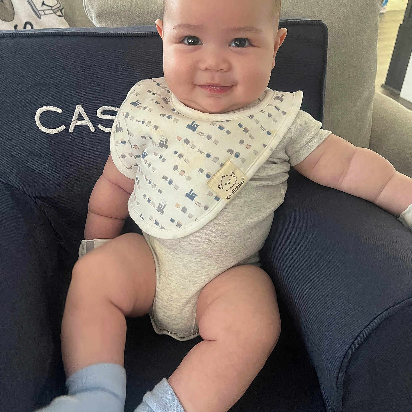 Cassius joined the competition — help win amazing prizes! baby, babylaughing, blonde, chair, clothing, cushion, diaper, face, furniture, happy, head, homedecor, hosiery, person, photography, portrait, sitting, sleeve, smile, sock