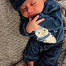 newborn, baby, sleeping, blue_outfit, hat, snowman_design, blanket, cozy, cute, infant, soft_texture, peaceful, fingers, toes, clothing, person, portrait, indoors, rest, child