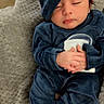 baby, sleeping, blue_clothing, hat, blanket, soft_texture, infant, peaceful, hands_clasped, bare_feet, indoors, cozy, cute, portrait, child, resting, newborn, comfort, warm, relaxed