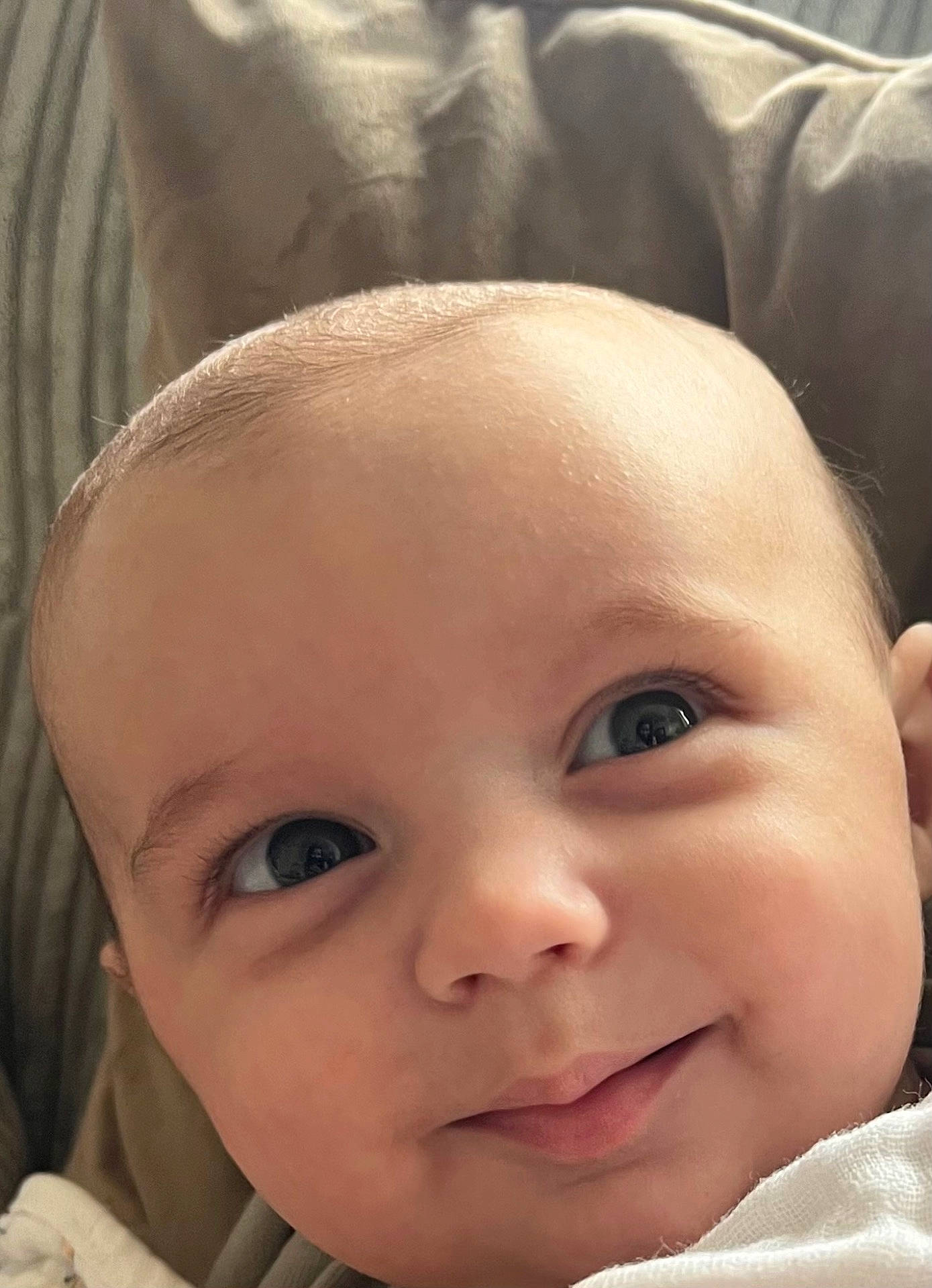 George is registered to the contest to win money with this photo: baby, babylaughing, cushion, face, happy, head, homedecor, newborn, person, photography, portrait, skin, smile