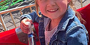 Amy a rejoint le concours — aidez-le/la à gagner de superbes lots ! child, smiling, amusement_ride, denim_jacket, handrail, outdoor, colorful_background, mushrooms, rainbow, fairy_tale_theme, sunlight, playful, young_girl, holding, metal_bar, park, fun, portrait, happy, casual_clothing