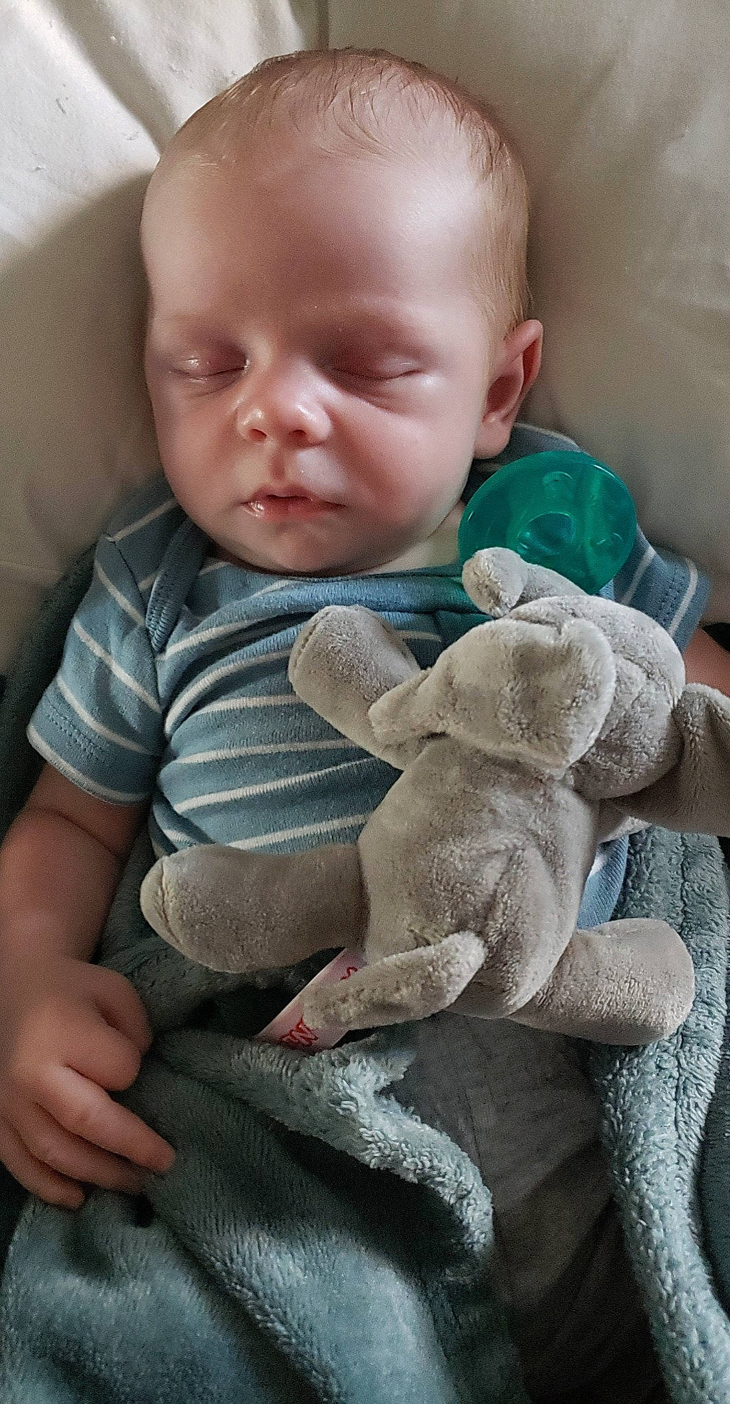 Liam is registered to the contest to win money with this photo: baby, baby_products, baby_sleeping, baby_toddler_clothing, cheek, child, comfort, eye, finger, grass, grey, head, linens, pattern, person, play, sitting, skin, sock, toddler