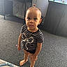 Kalani joined the competition — help win amazing prizes! toddler, child, barefoot, striped_shirt, jewelry, earrings, necklace, indoor, carpet, desk, shoes, aquarium, fish_tank, cabinet, curious, person, young_child, standing, room, floor