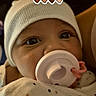 baby, infant, pacifier, hat, white_hat, polka_dot, clothing, face, close_up, cute, newborn, child, portrait, indoor, baby_girl, baby_boy, skin, eyes, headwear, cozy