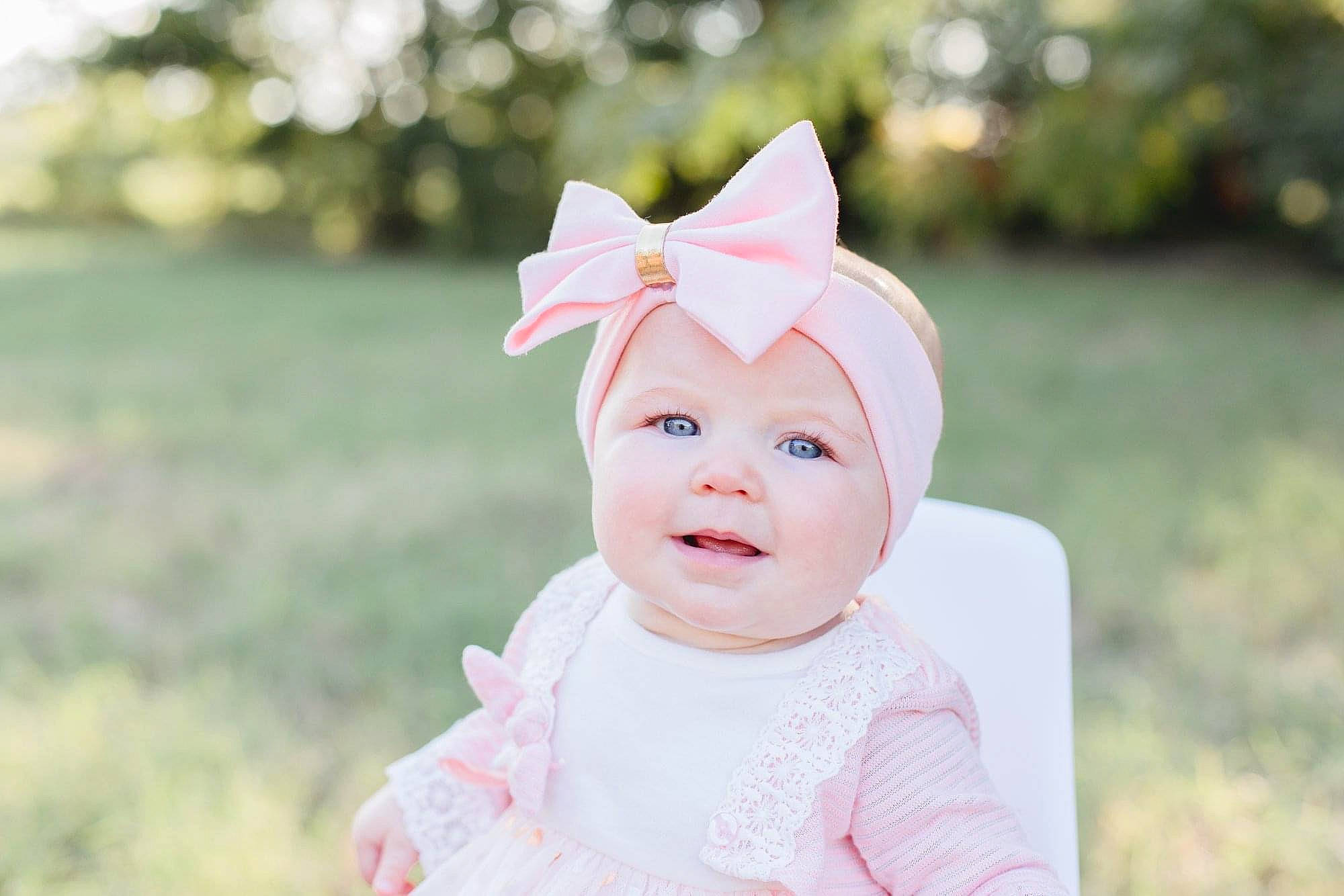 Evelyn joined the competition — help win amazing prizes! baby, child, ear, face, hair_accessory, happy, head, headgear, headwear, person, photograph, photography, pink, portrait_photography, skin, smile, toddler