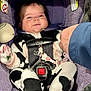 baby, child, car_seat, onesie, cow_print, pacifier_clip, hand_holding, purple, seatbelt, smile, infant, cute, indoor, clothing, person, sitting, safety_harness, plush, cozy, portrait