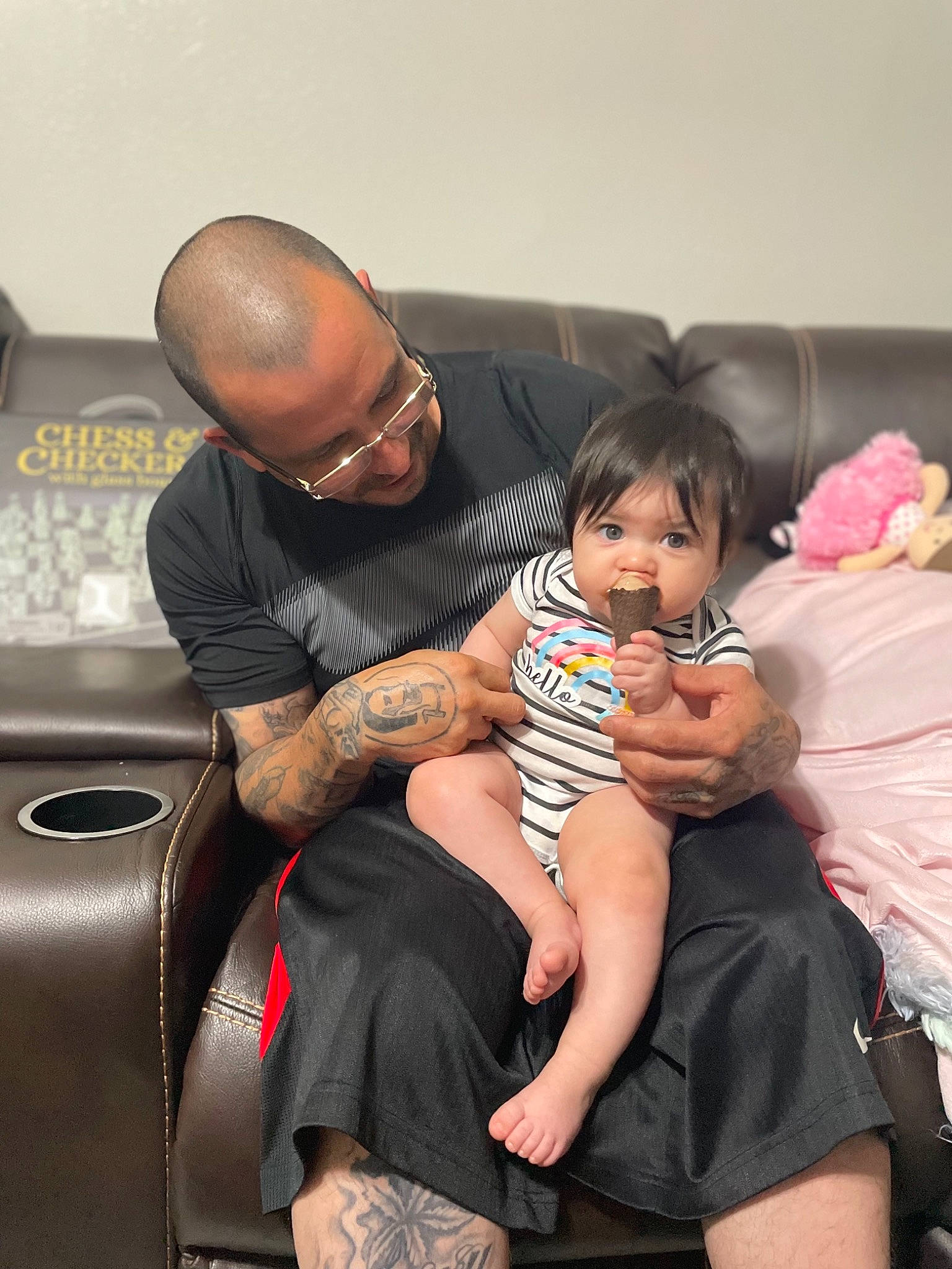 Avelina is registered to the contest to win money with this photo: automotive_design, baby, comfort, event, eyewear, fun, glasses, happy, hat, human_leg, interaction, joint, lap, leg, motor_vehicle, muscle, person, skin, sunglasses, thigh