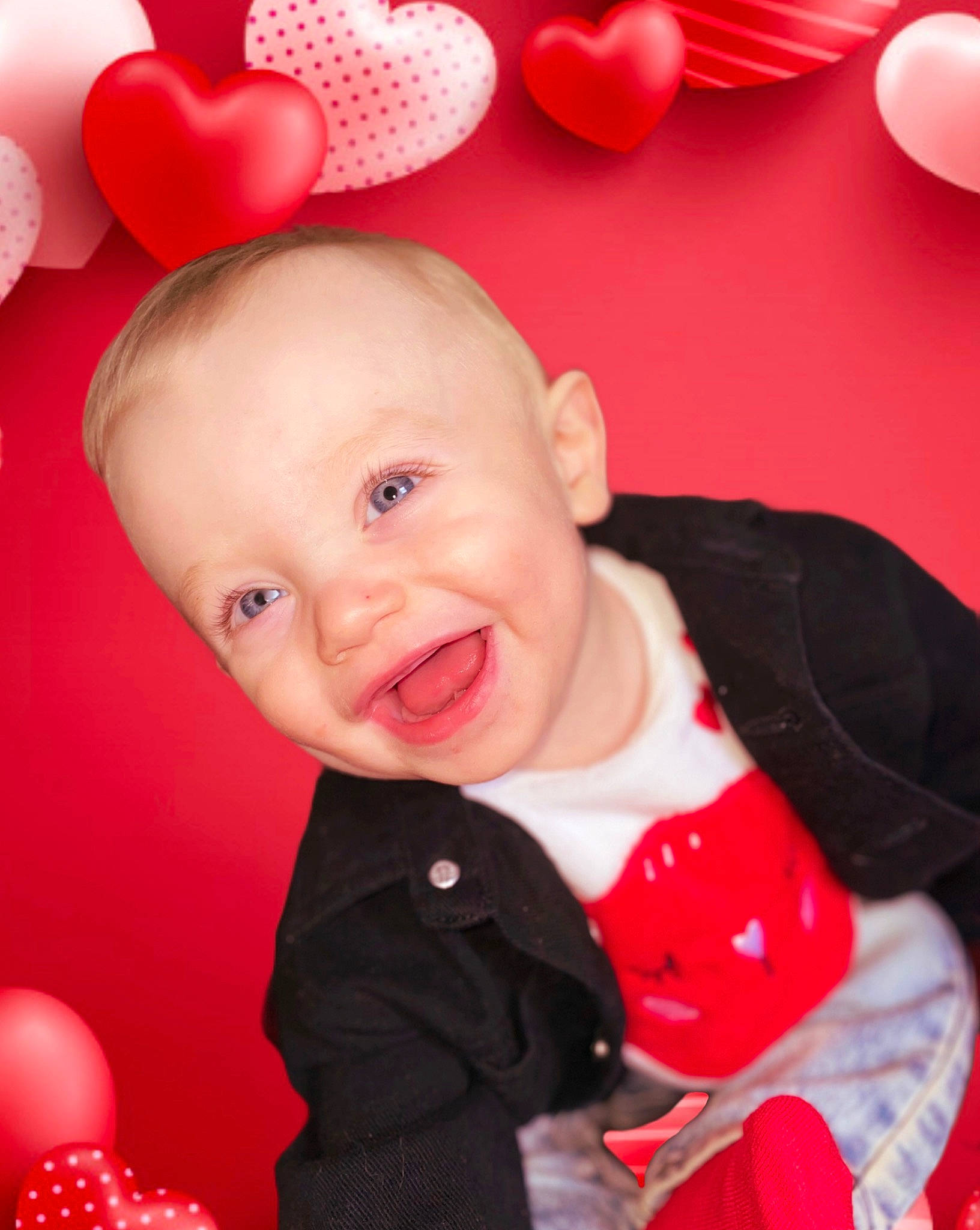 Ryder is registered to the contest to win money with this photo: baby, baby_toddler_clothing, balloon, cheek, child, event, eye, happy, head, holiday, laugh, magenta, organ, party_supply, pattern, person, pink, red, sleeve, smile