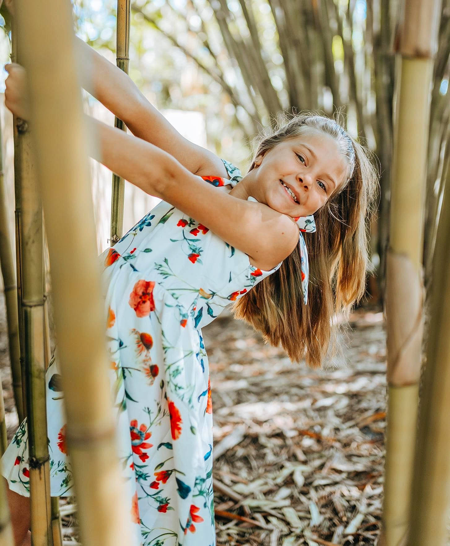 Ava Grace is registered to the contest to win money with this photo: branch, dress, fashion, fun, grass, happy, human, joy, leg, leisure, mammal, people_in_nature, person, plant, smile, standing, sunlight, textile, tree, vertebrate