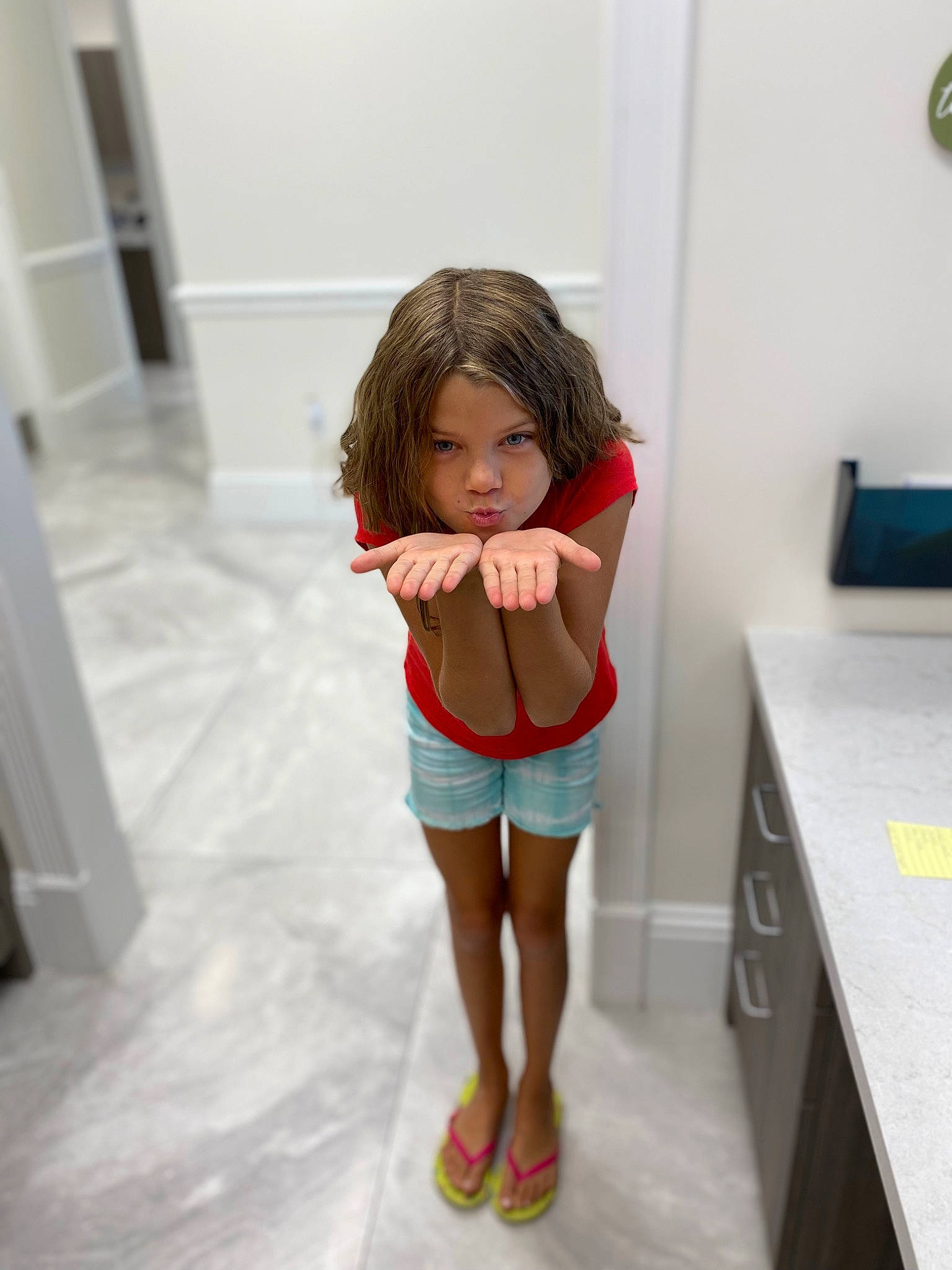 Ava Grace is registered to the contest to win money with this photo: brown_hair, fashion_design, floor, flooring, human_leg, joint, knee, leg, magenta, person, room, sandal, shorts, shoulder, sock, sportswear, t_shirt, thigh, toddler, trunk