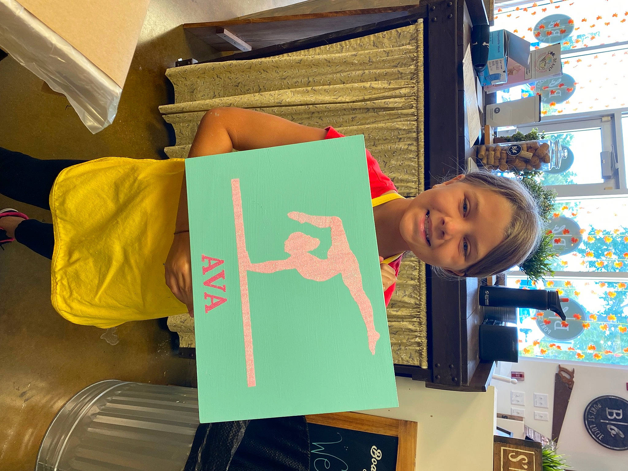 Ava Grace is registered to the contest to win money with this photo: art, comfort, design, font, fun, graphic_design, joy, machine, paper_product, person, publication, room, smile, t_shirt, textile, travel, visual_arts