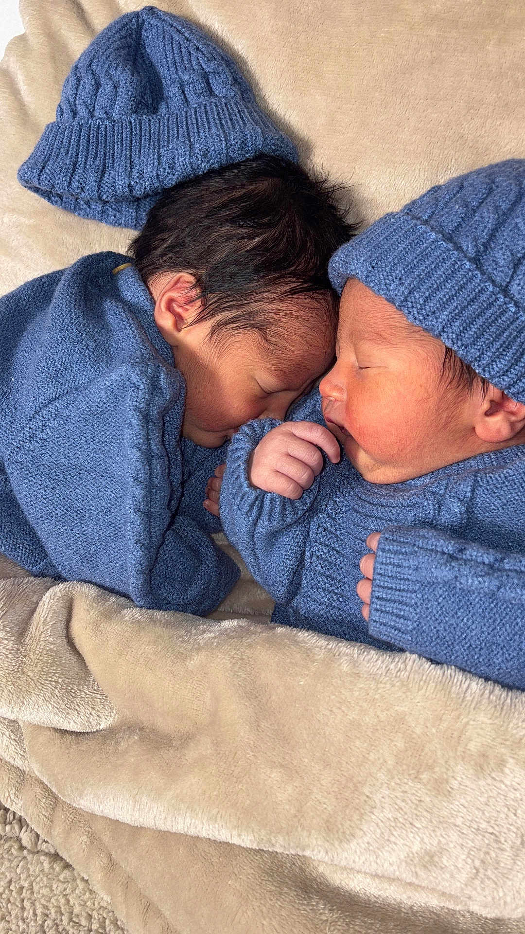 Christophermaximus is registered to the contest to win money with this photo: newborn, baby, infant, sleeping, blue_hat, blue_sweater, knitwear, blanket, soft_texture, cozy, cute, face, skin, hand, peaceful, indoors, portrait, two_babies, resting, closeup