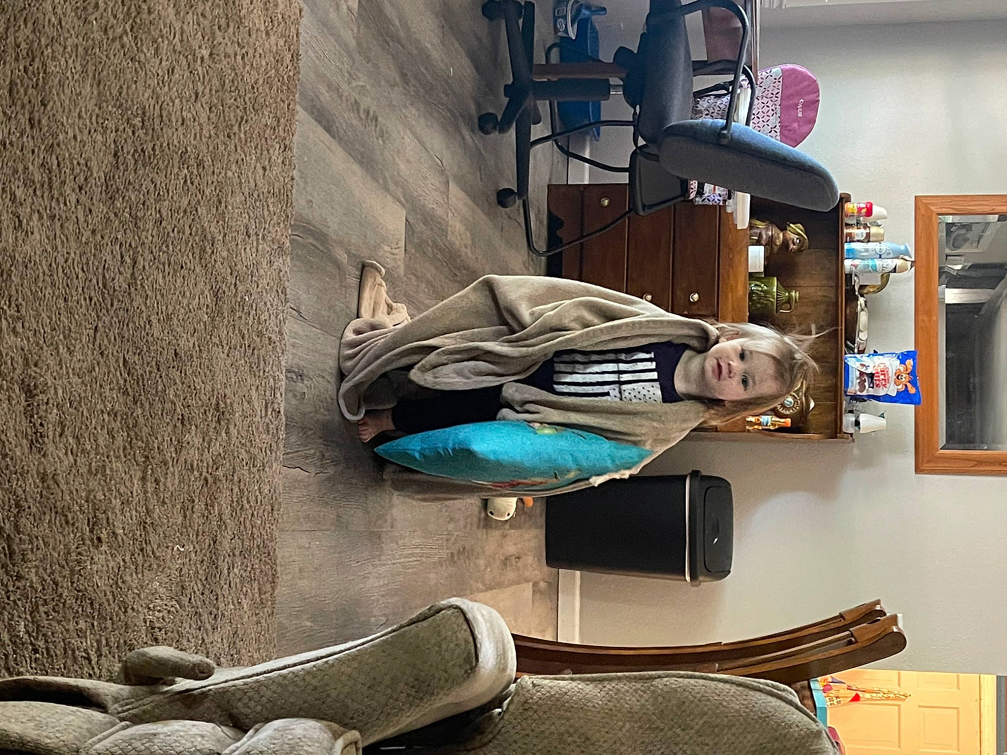 Kimberly is registered to the contest to win money with this photo: backpack, bag, baggage, carmine, comfort, concrete, denim, flooring, foot, hat, human_leg, luggage_and_bags, machine, person, picture_frame, room, shelf, shelving, sitting, travel