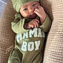 baby, infant, child, cute, green_outfit, hat, lying_down, quilted_blanket, cozy, portrait, small_hands, curious, relaxed, indoors, soft_lighting, close_up, face, human, sleepwear, baby_boy