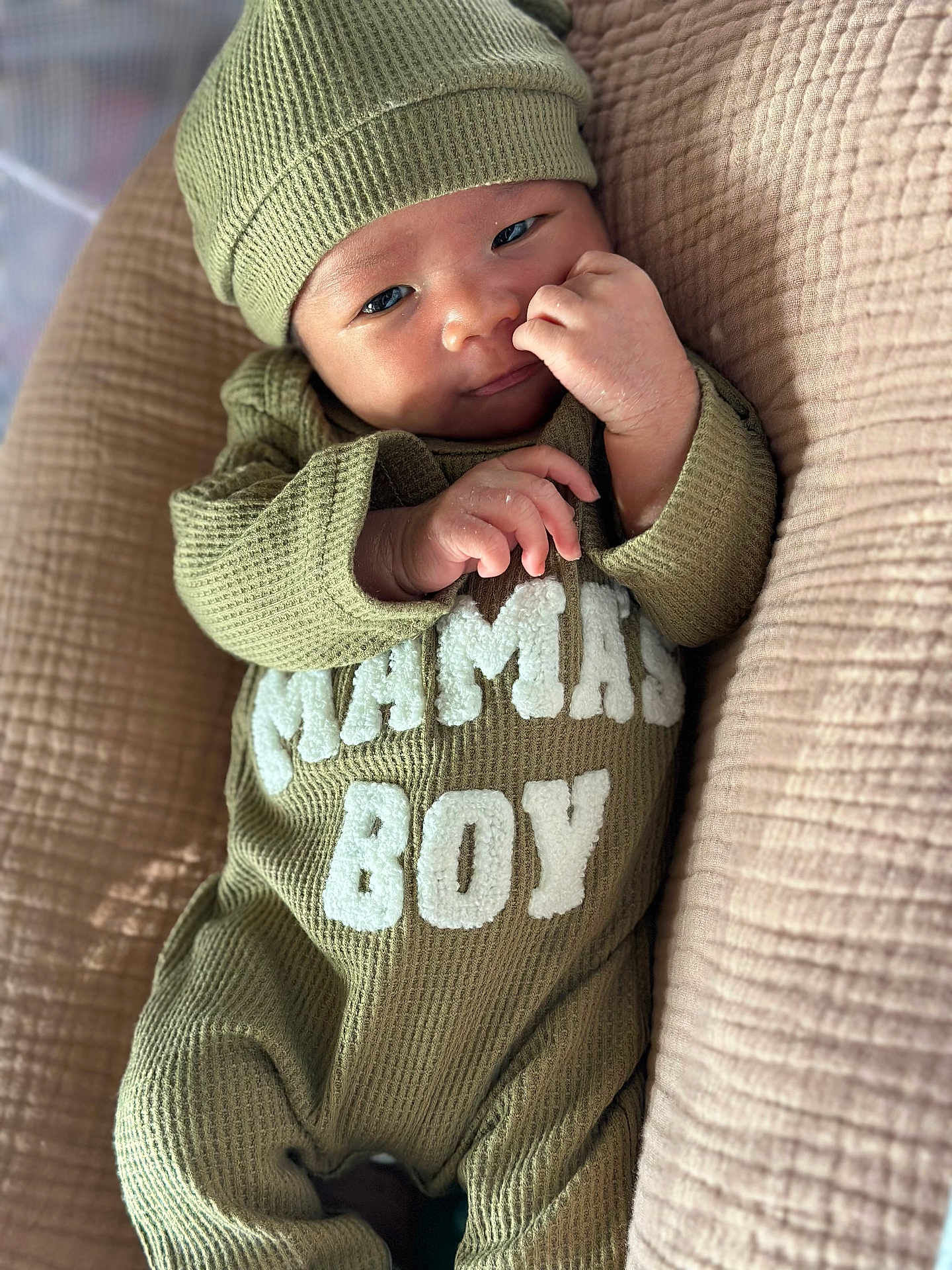 Kyren joined the competition — help win amazing prizes! baby, infant, child, cute, green_outfit, hat, lying_down, quilted_blanket, cozy, portrait, small_hands, curious, relaxed, indoors, soft_lighting, close_up, face, human, sleepwear, baby_boy