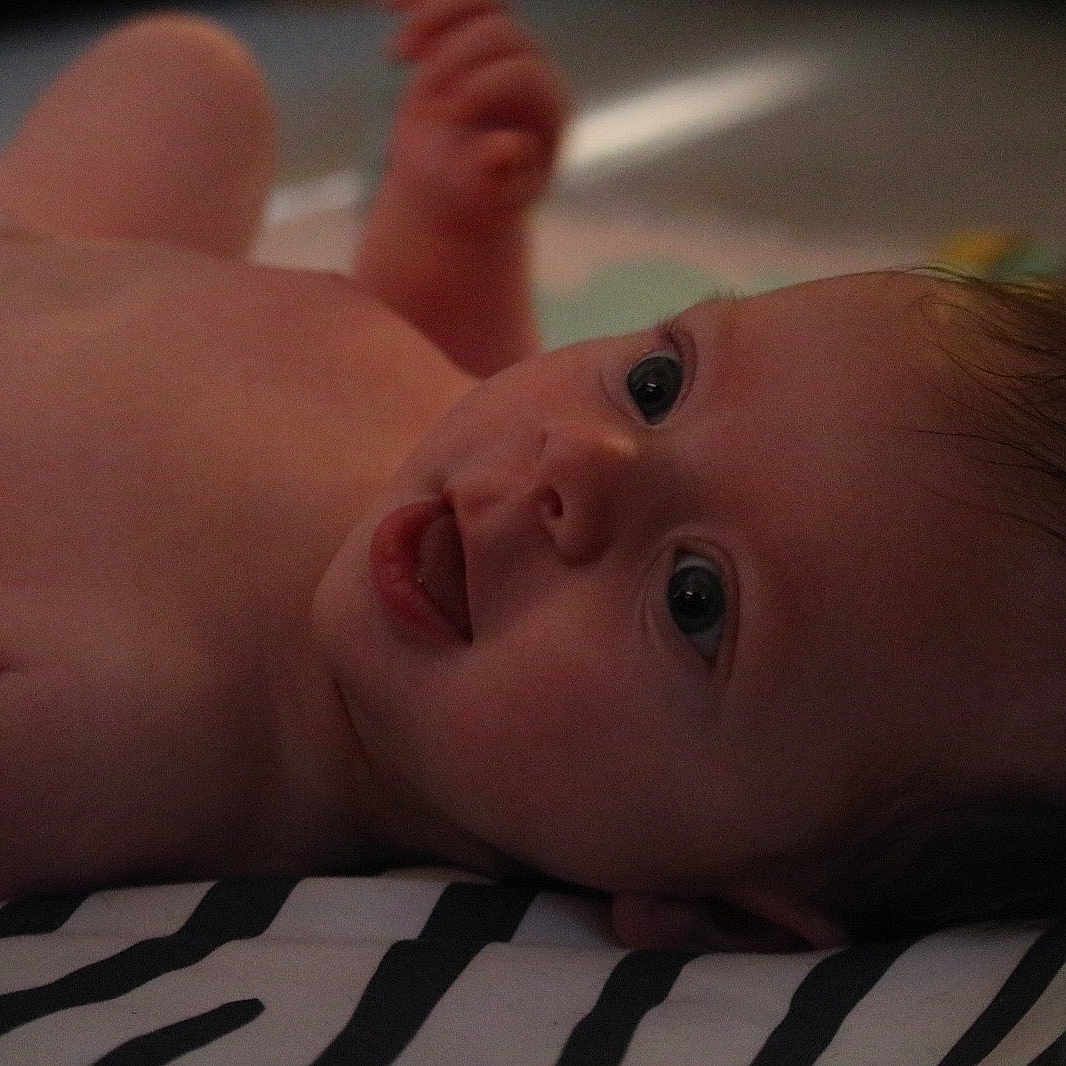 Abel joined the competition — help win amazing prizes! baby, child, closeup, cute, expression, eyes, face, head, human, indoors, infant, lying_down, portrait, resting, skin, skin_texture, soft_light, striped_blanket, tongue, young