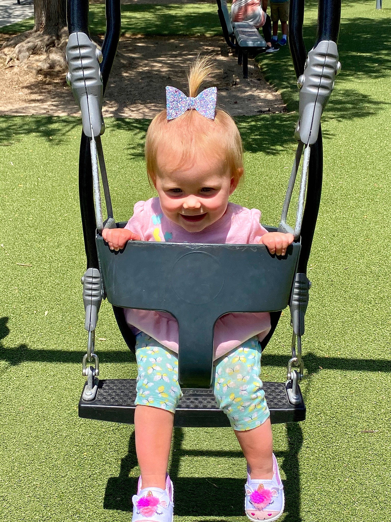 Avalon is registered to the contest to win money with this photo: child, grass, joy, leisure, outdoor_play_equipment, person, pink, playground, product, public_space, recreation, smile, swing, toddler