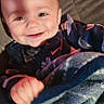 Thor is registered to the contest to win money with this photo: baby, blanket, bodypart, clothing, coat, face, finger, furniture, hand, happy, head, jacket, laughing, newborn, pants, person, photography, portrait, quilt, smile