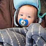 Thor is registered to the contest to win money with this photo: baby, bed, blanket, bonnet, cap, clothing, couch, face, furniture, hat, head, homedecor, hood, linen, newborn, person, photography, portrait, quilt, towel