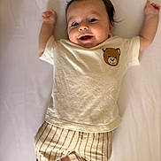 Rafael a rejoint le concours — aidez-le/la à gagner de superbes lots ! arms_up, baby, barefoot, child, clothing, cute, face, happy, indoors, infant, lying_down, person, portrait, shirt, smile, soft_light, striped_pants, teddy_bear, white_background, young_child