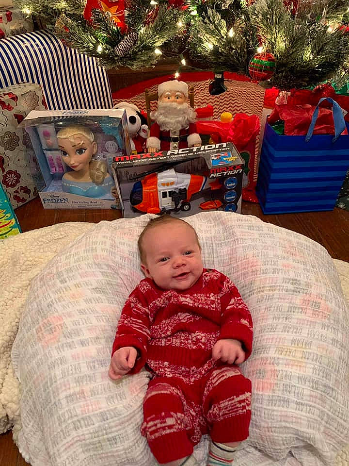 Deacon is registered to the contest to win money with this photo: baby, baby_toddler_clothing, child, christmas, christmas_decoration, christmas_eve, christmas_ornament, comfort, head, holiday, holiday_ornament, home_accessories, human, interior_design, mouth, nose, ornament, person, red, toddler