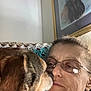 affection, blanket, brown_dog, casual, close_up, couch, dog, earrings, eyewear, face, framed_picture, glasses, head, indoor, love, pet, portrait, relaxation, skin_texture, woman