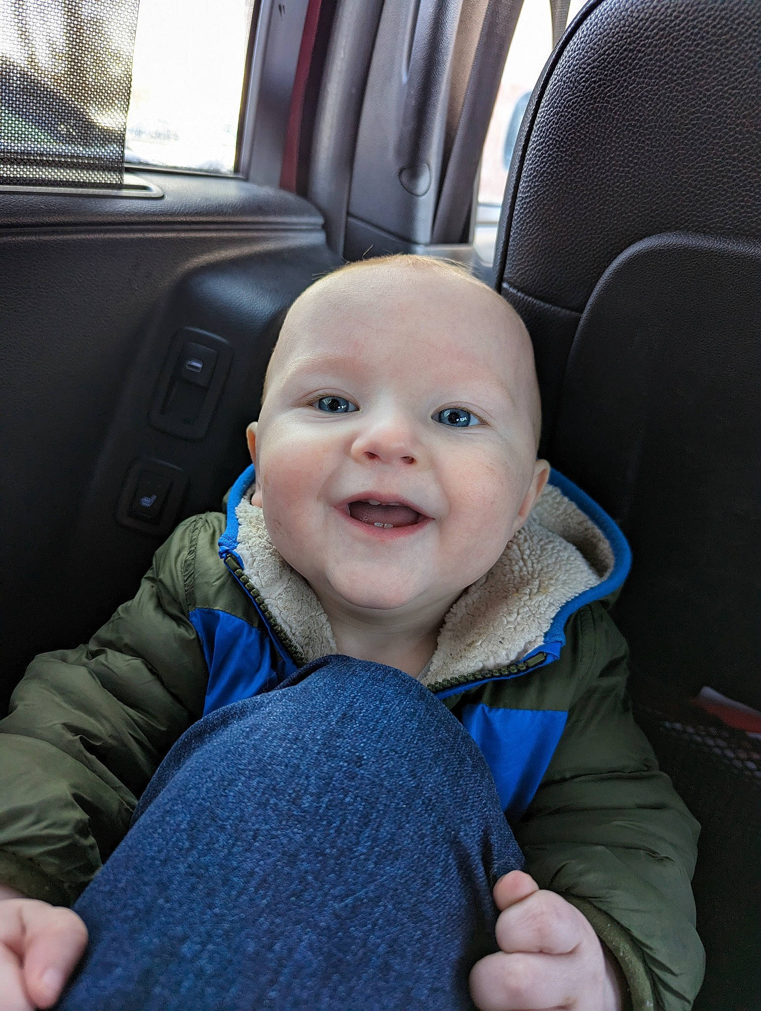 Connor is registered to the contest to win money with this photo: auto_part, baby, baby_toddler_clothing, car_seat, car_seat_cover, cheek, comfort, electric_blue, family_car, finger, gesture, happy, head, head_restraint, person, product, seat_belt, smile, thumb, toddler