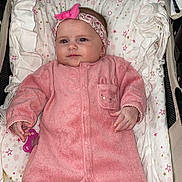 Isalya participe au concours pour gagner de l'argent avec cette photo : baby, pink_onesie, headband, pacifier, stroller, pillow, blanket, infant, cute, face, soft_toys, child, star_pattern, sleepwear, comfort, smile, person, indoors, resting, newborn