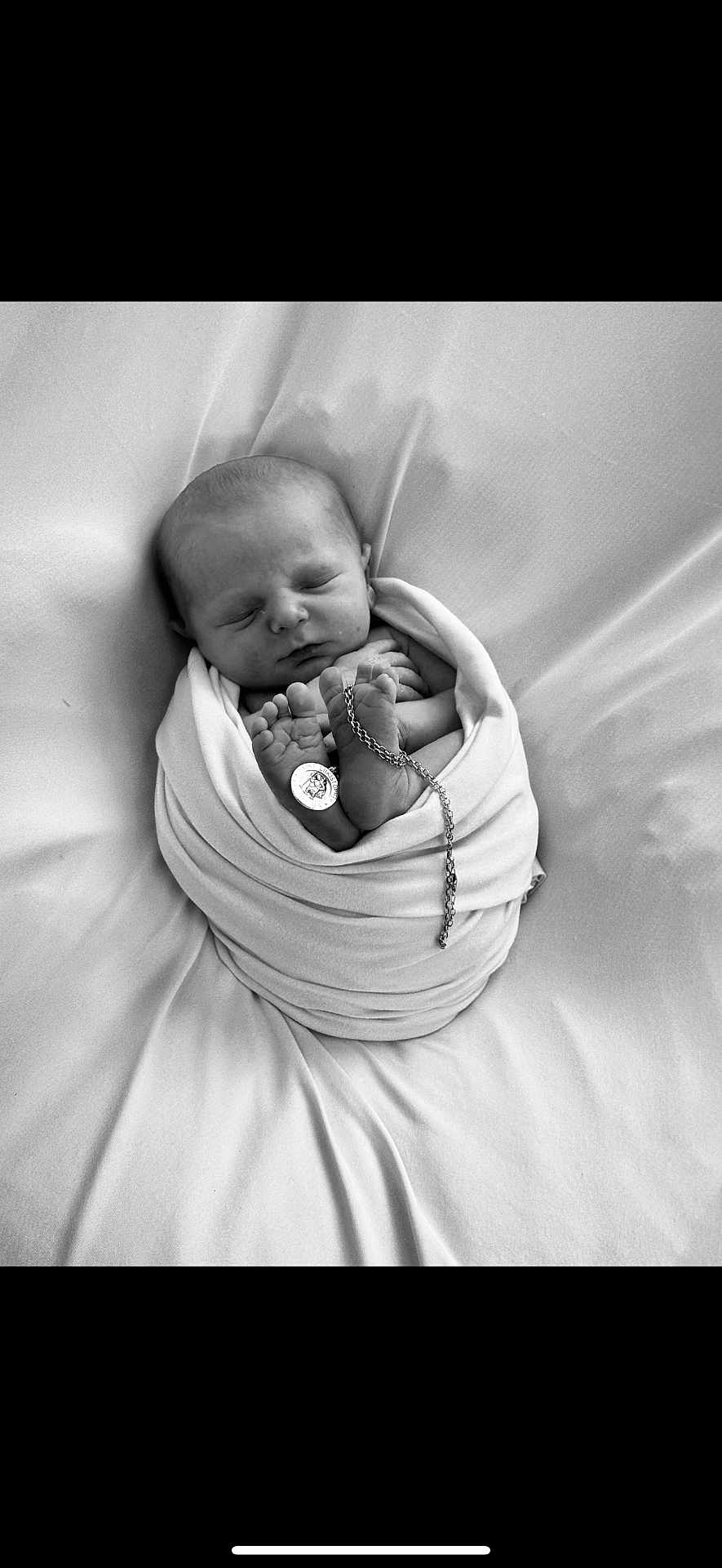 Wrenley-Reign joined the competition — help win amazing prizes! newborn, baby, sleeping, wrapped, blanket, feet, chain, pendant, black_and_white, portrait, infant, peaceful, soft, cute, tiny, resting, closeup, monochrome, cozy, swaddled