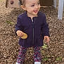 Lyna participe au concours pour gagner de l'argent avec cette photo : toddler, child, playground, wood_chips, biscuit, smiling, tongue_out, jacket, floral_pants, white_shoes, outdoor, leaves, play_equipment, happy, person, cute, young_child, standing, nature, daylight