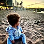 Inaïa a rejoint le concours — aidez-le/la à gagner de superbes lots ! baby, beach, bridge, casual, child, curly_hair, evening, nature, onesie, outdoor, pacifier, people, relaxation, sand, scenery, sitting, sky, sunset, warm_clothing, water