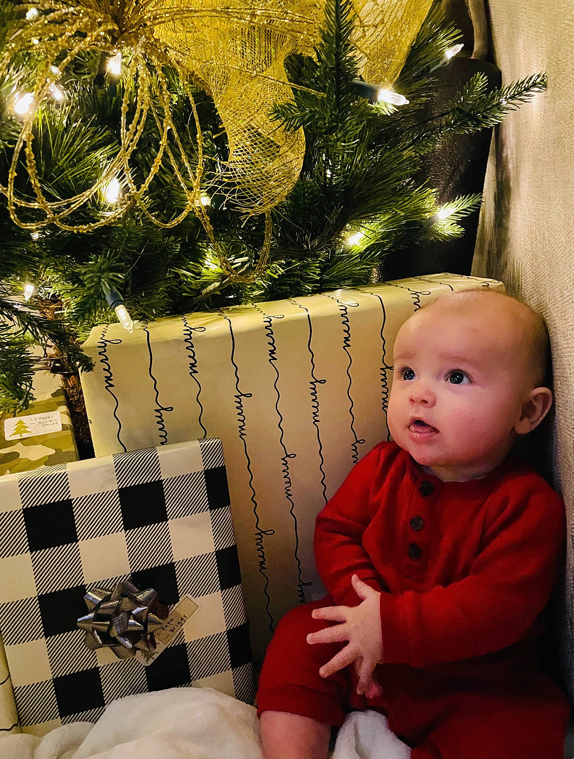 Briggs joined the competition — help win amazing prizes! baby, baby_toddler_clothing, christmas, christmas_decoration, christmas_eve, christmas_ornament, christmas_tree, conifer, event, evergreen, happy, holiday, holiday_ornament, lap, ornament, person, plant, sitting, toddler, tree