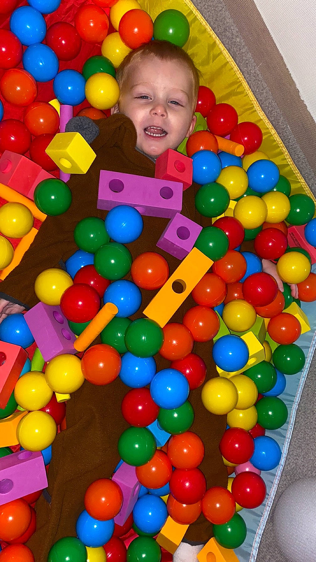 Cameron is registered to the contest to win money with this photo: baby, ball, ball_pit, child, circle, event, fun, leisure, mixture, party_supply, person, plastic, play, playground, product, recreation, smile, sweetness, toddler, toy
