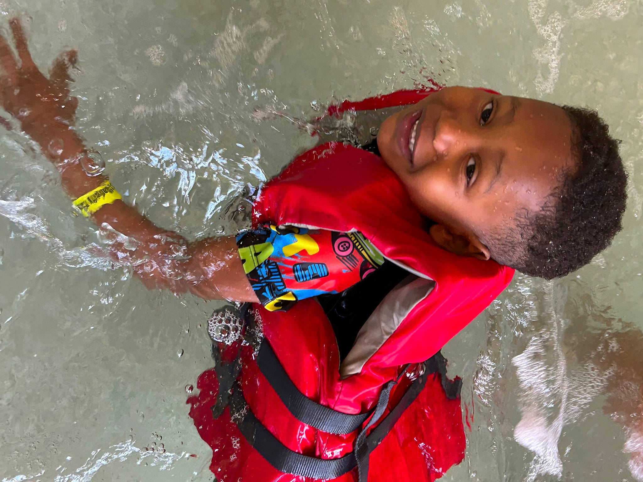 Jaqualyn is registered to the contest to win money with this photo: bathing, child, fun, happy, joy, leisure, person, personal_protective_equipment, play, recreation, smile, toddler, vacation, water, wave, wind_wave