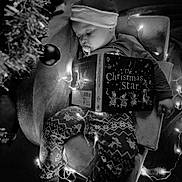 Bowen joined the competition — help win amazing prizes! baby, child, sleeping, christmas, holiday_lights, santa_hat, book, pajamas, chair, decorations, holiday, festive, indoors, cozy, pacifier, black_and_white, ornament, relaxing, cute, toddler