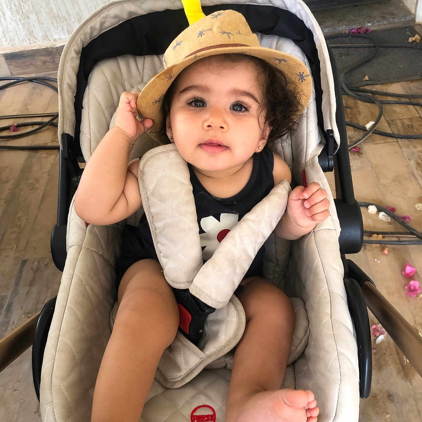 Danya participe au concours pour gagner de l'argent avec cette photo : baby, beige, cables, casual, child, clothing, curious, curly_hair, cute, floor, flower_petals, foot, hand, hat, indoor, portrait, seatbelt, stroller, tiles, toddler