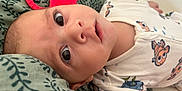 Adriann a rejoint le concours — aidez-le/la à gagner de superbes lots ! baby, infant, face, eyes, teether, red_teether, onesie, fish_pattern, blanket, leaf_pattern, lying_down, cute, closeup, skin, head, expression, child, indoors, soft, comfort