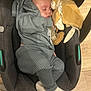 Adriann participe au concours pour gagner de l'argent avec cette photo : baby, sleeping, car_seat, plush_toy, lion_toy, gray_clothing, knitwear, socks, infant, cozy, face, child, wooden_floor, indoor, comfort, cute, peaceful, portrait, soft_toy, resting
