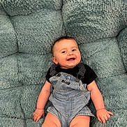 Dean joined the competition — help win amazing prizes! baby, child, smiling, denim, overalls, black_shirt, plush_cushion, teal, soft_texture, happy, infant, cute, portrait, sitting, skin, face, hand, leg, clothing, comfortable