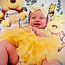 2_months, baby, baby_girl, blanket, bow, celebration, child, clothing, cute, happy, headband, infant, lying_down, milestone, plush_toy, smiling, soft_toys, tutu, winnie_the_pooh, yellow